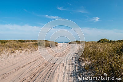 Sandy path leading toward the Atlantic Ocean, beneath a beautiful clear blue sky, Fire Island, NY Stock Photo