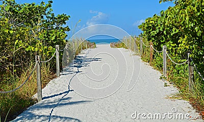 A Sandy Roped Path to a Blue Sea on the Beach Stock Photo