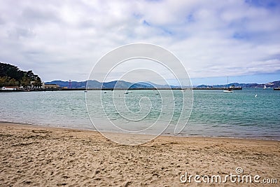 Sandy San Francisco beach looking out across Aquatic Cove towards Golden Gate Bridge Stock Photo