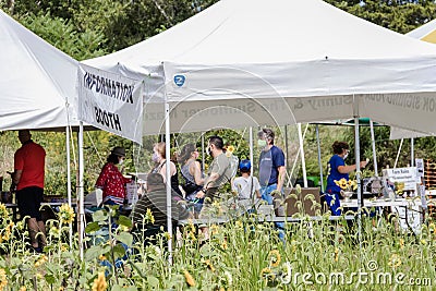 Social distance practiced as people enter information booth at the Sussex County Sunflower Maze Editorial Stock Photo