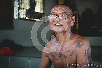 Cambodian buddhist monk with tatoos at temple Wat Krabi Riel Pagoda, Siem Reap Province, Cambodia Editorial Stock Photo