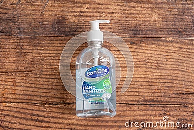 Sanione branded bottle of hand sanitizer with antibacterial aloe vera and in a recyclable plastic bottle dispenser Editorial Stock Photo