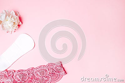 Sanitary napkin with a beautiful peony and underwear on a pink background, health care, monthly protection, reliable friend Stock Photo