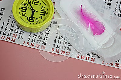 Sanitary pad, pen, calendar, clock on pink. Personal hygiene, the concept of feminine hygiene. Critical days, blood period, Stock Photo