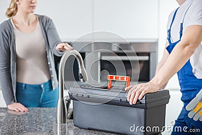 Sanitation technician with black toolbox Stock Photo