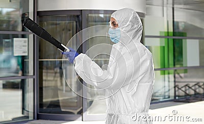 Sanitation worker in hazmat with pressure washer Stock Photo