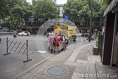 Sanitation workers cleaning up sewer debris Editorial Stock Photo