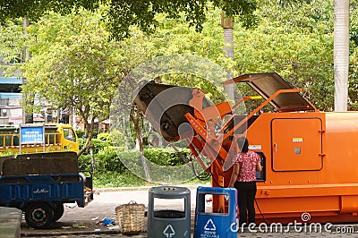 Sanitation workers loading and unloading garbage Editorial Stock Photo