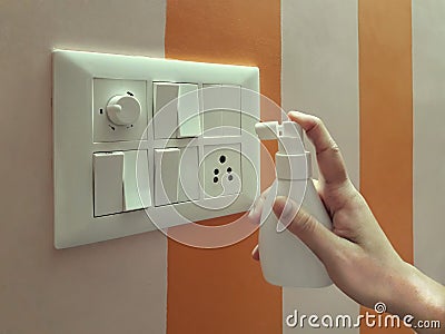 Sanitization of switch board for protection from corona virus spread. Stock Photo