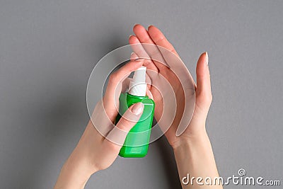 Sanitizer spray bottle in female hands. Coronavirus Disease Covid-19 prevention concept Stock Photo