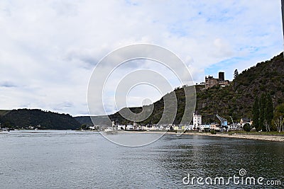 Sankt Goarshausen, Germany - 09 30 2021: Entry to Lorelei passage with passenger ship, waterfront of Sankt Goarshausen, Burg Katz Stock Photo