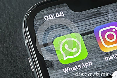 Whatsapp messenger application icon on Apple iPhone X smartphone screen close-up. Whatsapp messenger app icon. Social media icon. Editorial Stock Photo