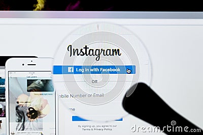 Instagram homepage website under a magnifying glass. Instagram is an online mobile photo sharing, video sharing and social network Editorial Stock Photo