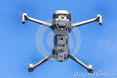 DJI Mavic 2 pro hovering over blue sky. DJI Mavic 2 Pro quadcopter or drone hovering in bright blue sky Editorial Stock Photo
