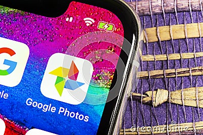 Google Photos application icon on Apple iPhone X screen close-up. Google Photos icon. Google photos application. Social media netw Editorial Stock Photo