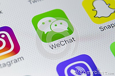 Wechat messenger application icon on Apple iPhone X smartphone screen close-up. Wechat messenger app icon. Social media network. Editorial Stock Photo