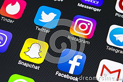 Apple iPhone X with icons of social media facebook, instagram, twitter, snapchat application on screen. Social media icons. Social Editorial Stock Photo