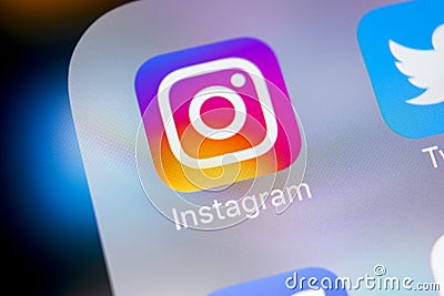 Instagram application icon on Apple iPhoneX smartphone screen close-up. Instagram app icon. Social media icon. Social network Editorial Stock Photo