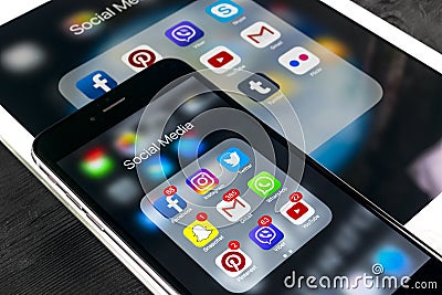 Apple iPhone 7 and iPad pro with icons of social media facebook, instagram, twitter, snapchat application on screen. Smartphone Editorial Stock Photo