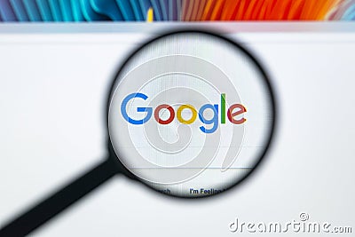 Google homepage on the Apple iMac monitor screen under a magnifying glass. Google is world`s most popular search engine Editorial Stock Photo