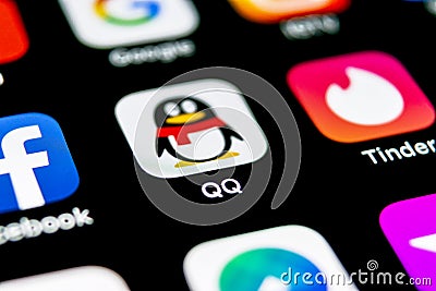 QQ messenger application icon on Apple iPhone X smartphone screen close-up. QQ messenger app icon. Social media network Editorial Stock Photo