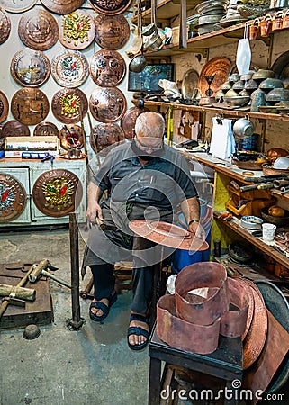 Sanli Urfa, Turkey: September 12 2020: A Coppersmith Busily Making a Copper Plate in Copper Bazaar Editorial Stock Photo