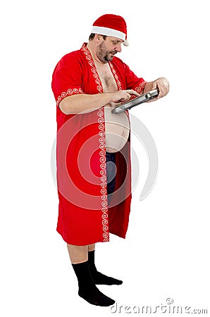 Fat Santa attentively looks at scales Stock Photo