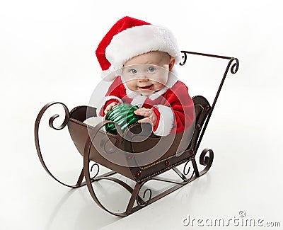 Santa baby sitting in a sleigh Stock Photo