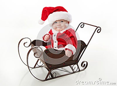 Santa baby sitting in a sleigh Stock Photo