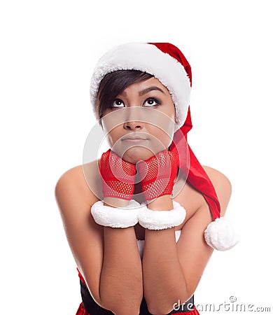 santa christmas woman looking to the side thinking happy and playful. Asian christmas girl Stock Photo