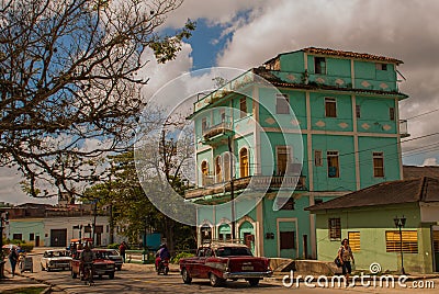SANTA CLARA, CUBA: The usual street in the city. Green multi-storey building. Editorial Stock Photo