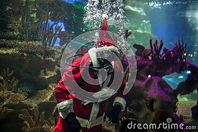 Santa Claus with aqualung under water in aquarium Stock Photo