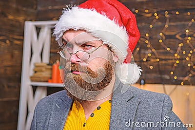 Santa claus attributes concept. Man bearded mature guy serious face wear santa hat with fur and old fashioned eyeglasses Stock Photo