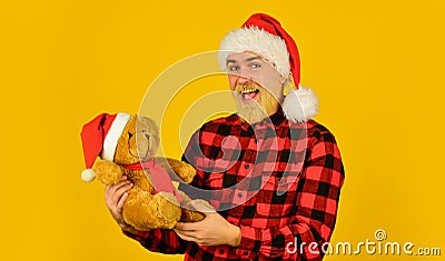 Santa Claus. Bearded man celebrate christmas. Christmas memories from childhood. Kind hipster with teddy bear. Charity Stock Photo