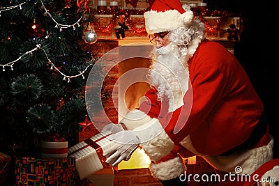 Santa Claus brought gifts for Christmas and having a rest Stock Photo