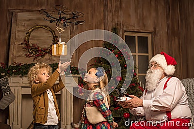 Santa Claus with children using hexacopter drone Stock Photo