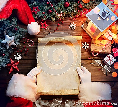 Santa Claus Desk Reading Wish List With Ornament Stock Photo