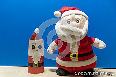 Santa Claus doll on blue background Stock Photo