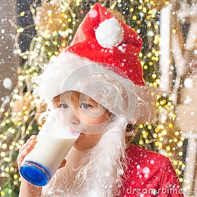 Christmas childs in snow. Santa Claus enjoys cookies and milk left out for him on Christmas eve. Merry Christmas. Santa Stock Photo