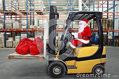 Santa Claus forklift operator in warehouse Stock Photo