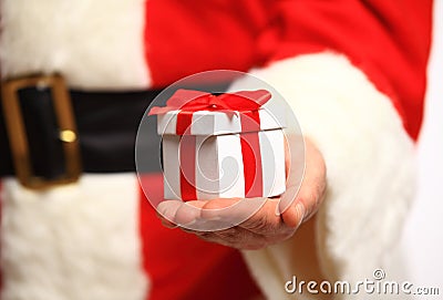 Santa Claus gloved hands holding gift box Stock Photo