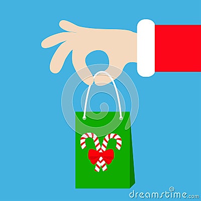 Santa Claus hand holding gift shopping paper bag with candy cane. Merry Christmas. Red costume fur. Giving present. Cute cartoon k Vector Illustration