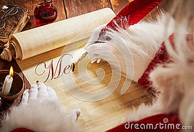 Santa Claus handwriting a Christmas greeting Stock Photo