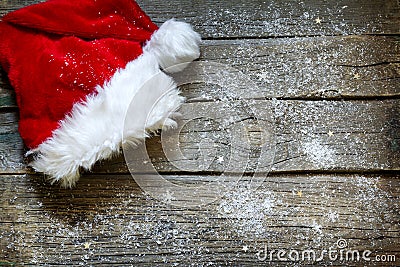 Santa Claus hat on vintage wooden boards christmas background Stock Photo