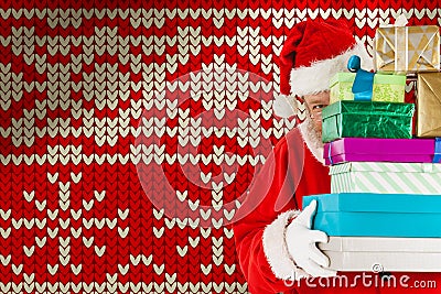 Composite image of santa claus hiding behind stack christmas gifts Stock Photo