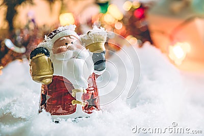 Santa claus hold the bell and star stand among pile of snow at silent night, light up the hopefulness and happiness in Merry chri Stock Photo