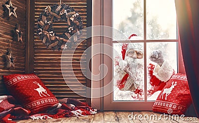 Santa Claus is knocking at window Stock Photo