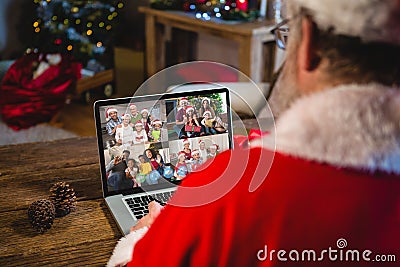 Santa claus making christmas laptop video call with four diverse familes Stock Photo
