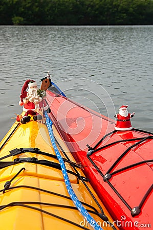 Santa Claus ornaments decorate holiday kayaks. Stock Photo