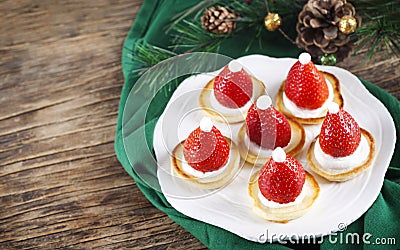 Santa Claus pancakes with whipped cream and strawberries, Christmas food idea Stock Photo